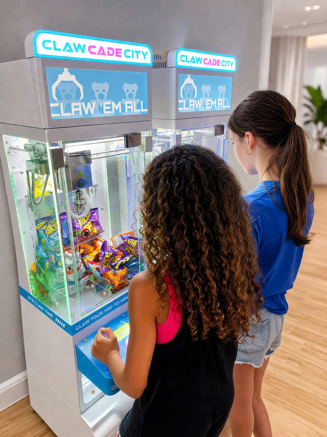 Kids winning prizes from claw machine party rental